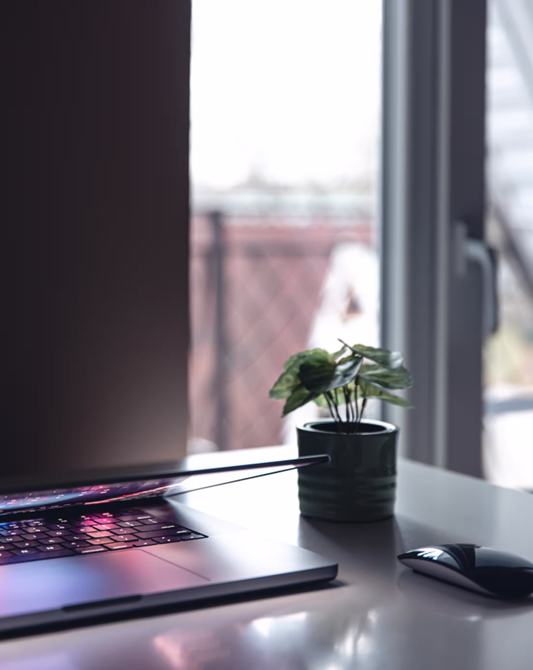 Minimalist workspace with laptop showing SaaS design and development workflow